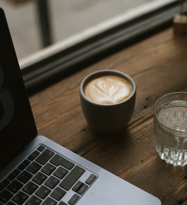 a laptop and a cup of coffee